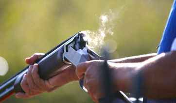 Closeup of the barrel of a smoking shotgun